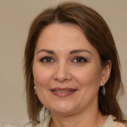 Joyful white adult female with medium  brown hair and brown eyes