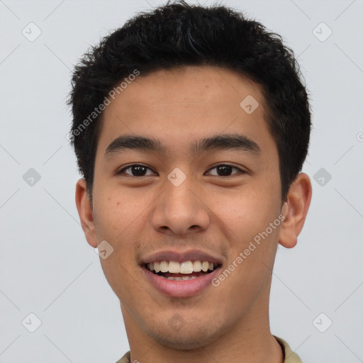 Joyful latino young-adult male with short  brown hair and brown eyes