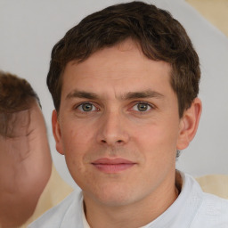 Joyful white young-adult male with short  brown hair and brown eyes