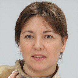 Joyful white adult female with medium  brown hair and brown eyes