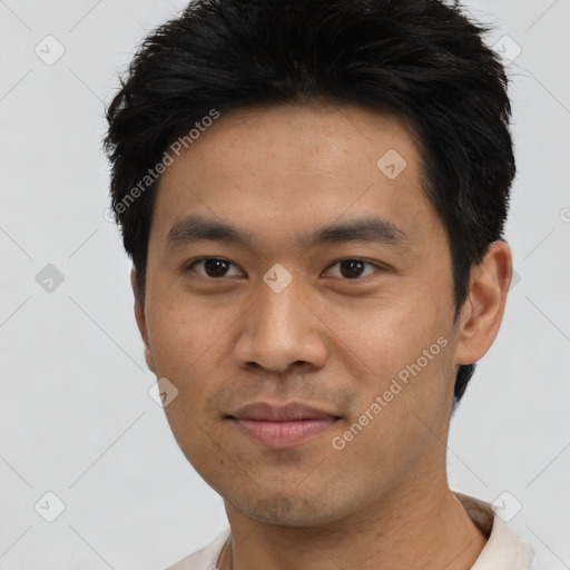 Joyful asian young-adult male with short  black hair and brown eyes