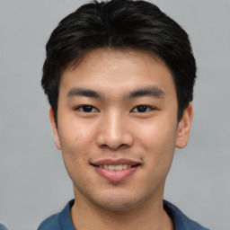 Joyful asian young-adult male with short  black hair and brown eyes