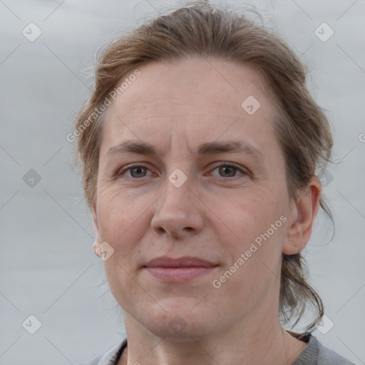 Joyful white adult female with medium  brown hair and grey eyes