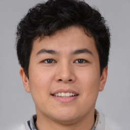 Joyful asian young-adult male with short  brown hair and brown eyes