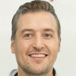 Joyful white adult male with short  brown hair and brown eyes