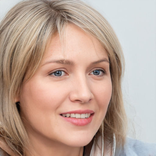 Joyful white young-adult female with long  brown hair and blue eyes