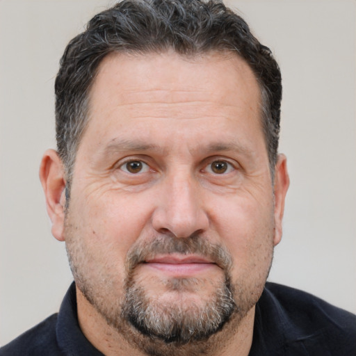 Joyful white middle-aged male with short  brown hair and brown eyes