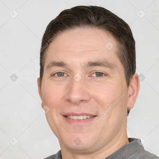 Joyful white adult male with short  brown hair and brown eyes