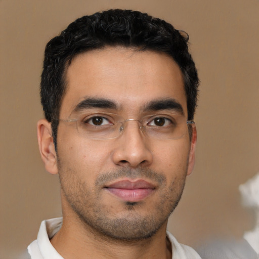 Joyful latino young-adult male with short  brown hair and brown eyes