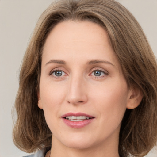 Joyful white young-adult female with medium  brown hair and green eyes