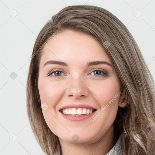 Joyful white young-adult female with long  brown hair and blue eyes