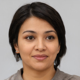 Joyful asian young-adult female with medium  brown hair and brown eyes