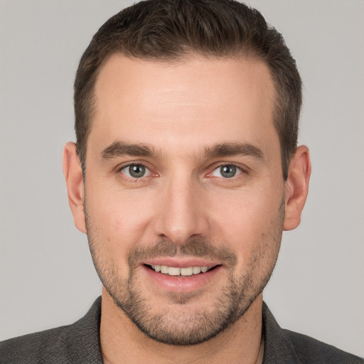 Joyful white young-adult male with short  brown hair and brown eyes