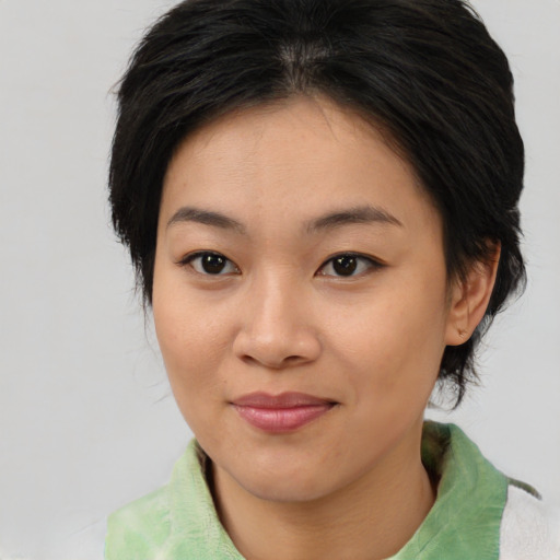 Joyful asian young-adult female with medium  brown hair and brown eyes