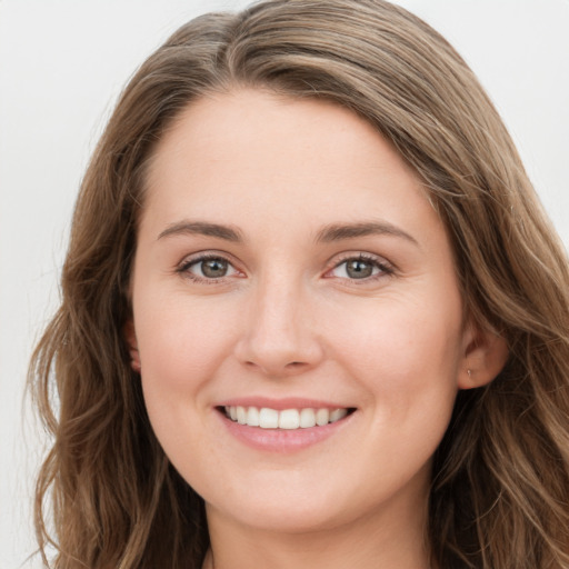 Joyful white young-adult female with long  brown hair and grey eyes