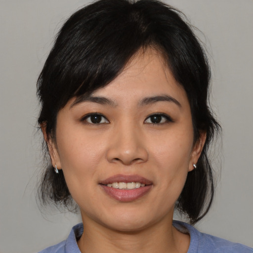 Joyful asian young-adult female with medium  black hair and brown eyes