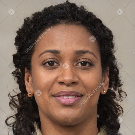 Joyful black young-adult female with long  brown hair and brown eyes