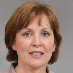 Joyful white adult female with medium  brown hair and grey eyes