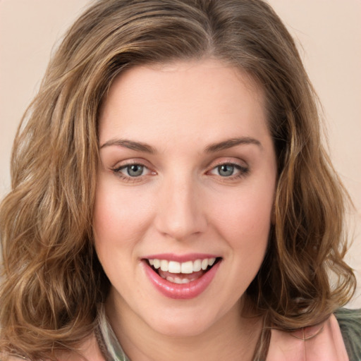 Joyful white young-adult female with long  brown hair and green eyes