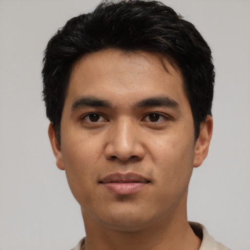 Joyful asian young-adult male with short  black hair and brown eyes