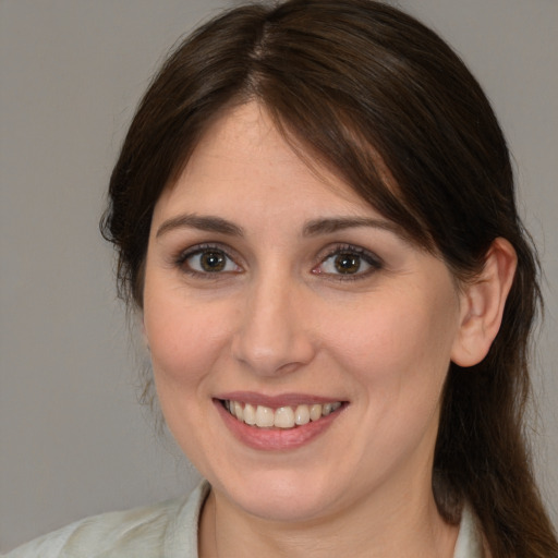 Joyful white young-adult female with medium  brown hair and brown eyes