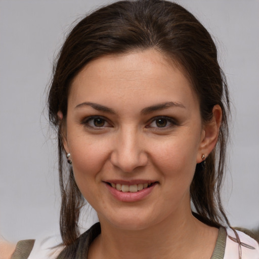 Joyful white young-adult female with medium  brown hair and brown eyes