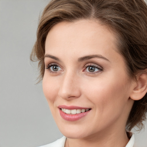 Joyful white young-adult female with medium  brown hair and blue eyes