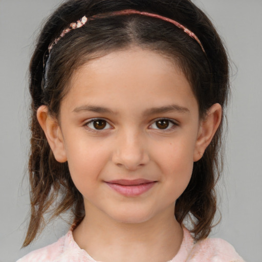 Joyful white child female with medium  brown hair and brown eyes