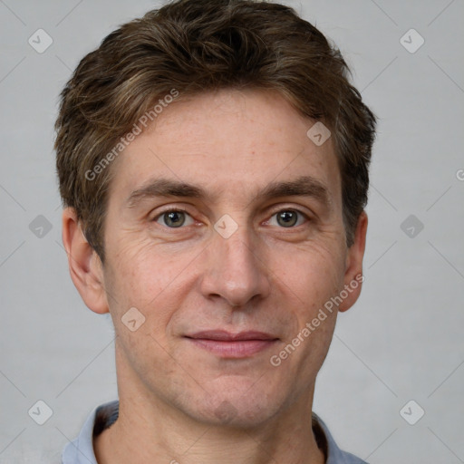 Joyful white adult male with short  brown hair and grey eyes