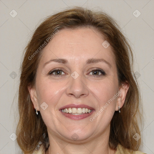 Joyful white adult female with medium  brown hair and blue eyes