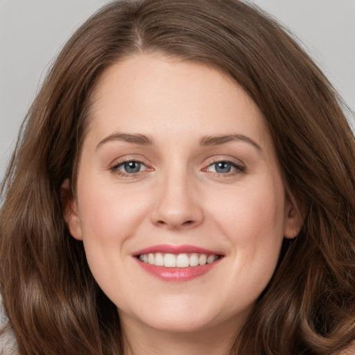 Joyful white young-adult female with long  brown hair and grey eyes