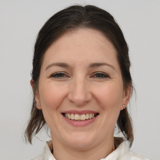 Joyful white adult female with medium  brown hair and brown eyes