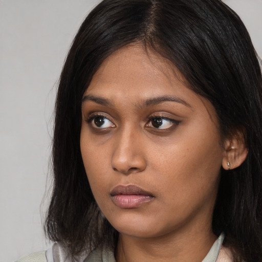 Neutral asian young-adult female with medium  brown hair and brown eyes