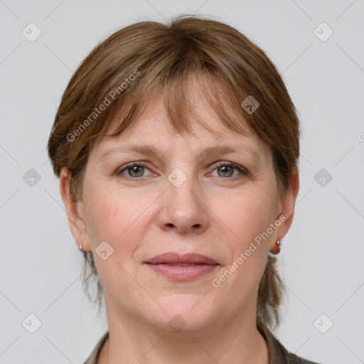 Joyful white adult female with medium  brown hair and grey eyes