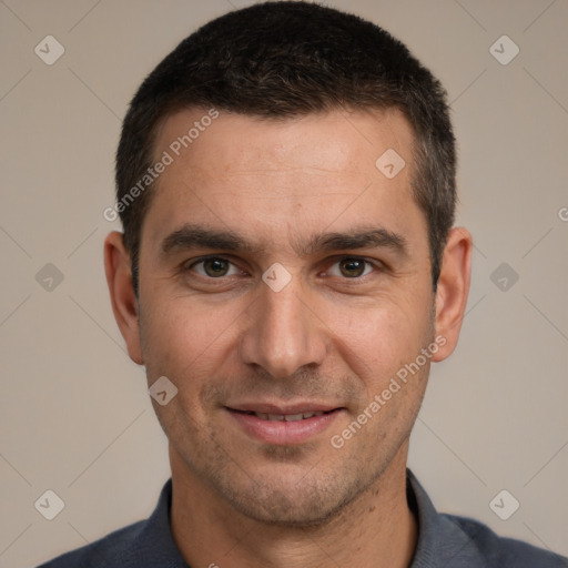 Joyful white adult male with short  black hair and brown eyes