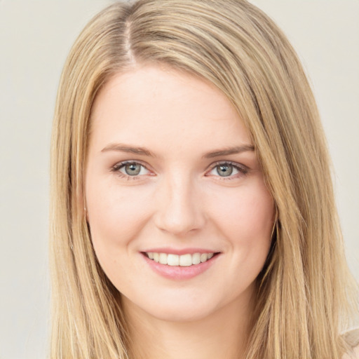 Joyful white young-adult female with long  brown hair and green eyes