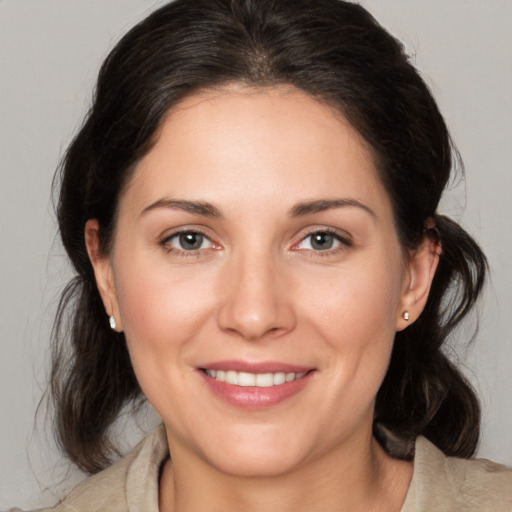 Joyful white young-adult female with medium  brown hair and brown eyes