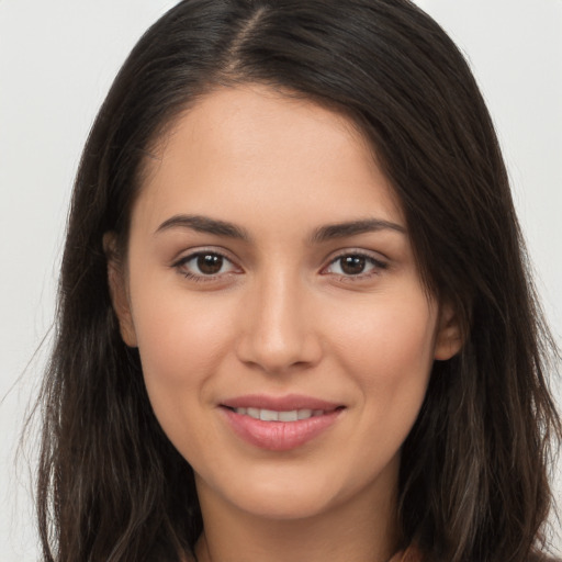 Joyful white young-adult female with long  brown hair and brown eyes