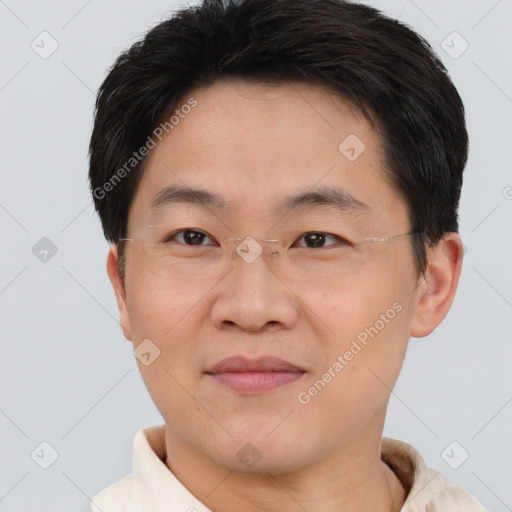 Joyful asian young-adult male with short  brown hair and brown eyes