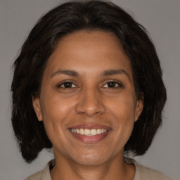 Joyful white adult female with medium  brown hair and brown eyes