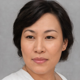 Joyful asian adult female with medium  brown hair and brown eyes