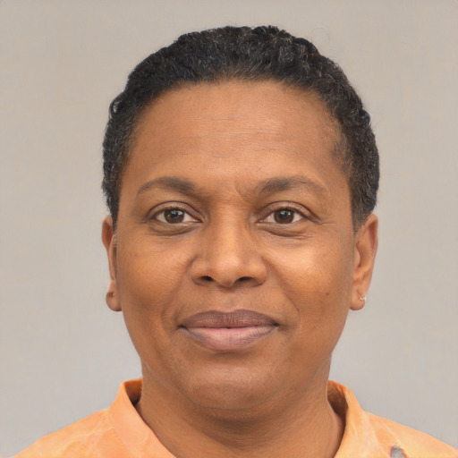 Joyful black adult female with short  black hair and brown eyes