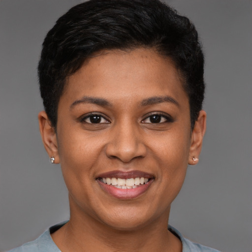 Joyful black young-adult female with short  brown hair and brown eyes