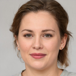 Joyful white young-adult female with medium  brown hair and green eyes