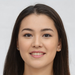 Joyful asian young-adult female with long  brown hair and brown eyes