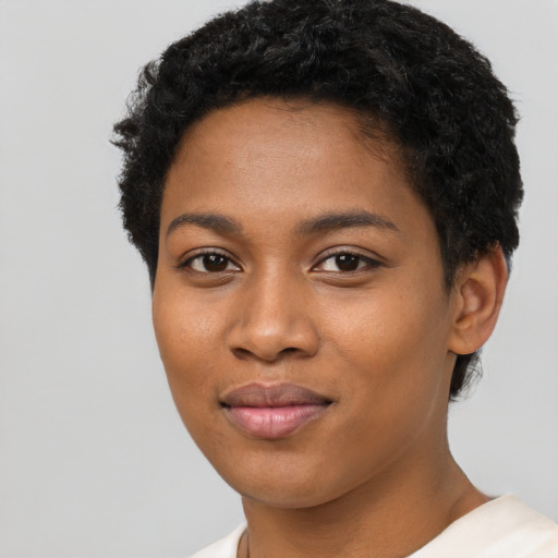 Joyful black young-adult female with short  black hair and brown eyes