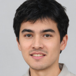 Joyful asian young-adult male with short  black hair and brown eyes