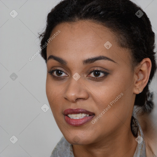 Joyful black young-adult female with long  black hair and brown eyes