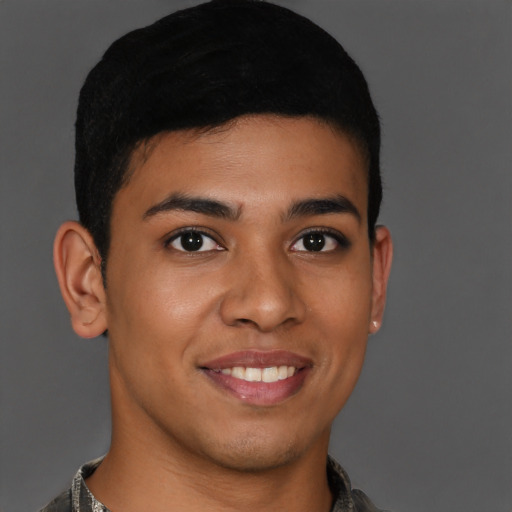 Joyful latino young-adult male with short  brown hair and brown eyes