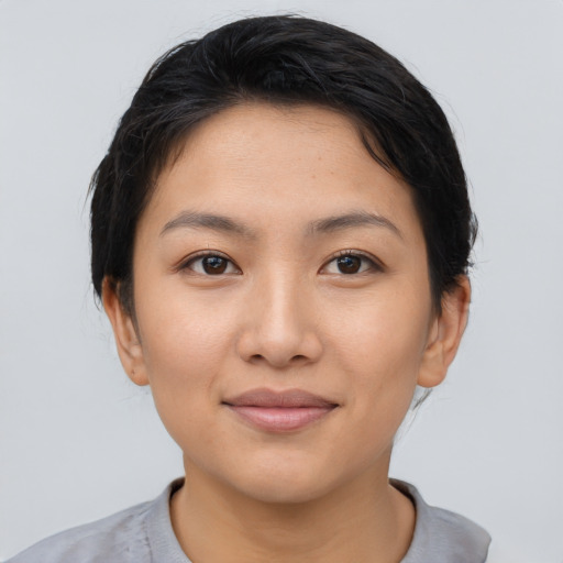 Joyful asian young-adult female with short  black hair and brown eyes